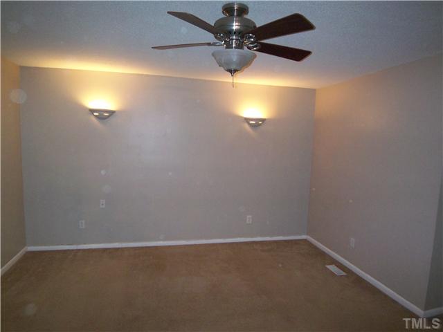 7300 Sandy Creek Drive Raleigh, NC 27615 - Photo 16 of 25 en empty room with a window and a fan