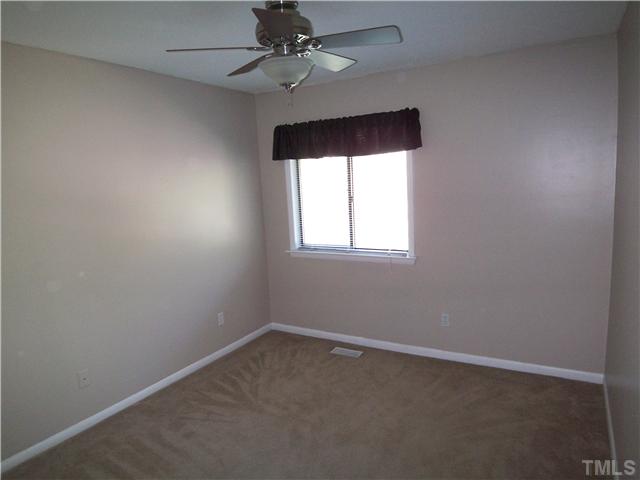 7300 Sandy Creek Drive Raleigh, NC 27615 - Photo 19 of 25 an empty room with a window
