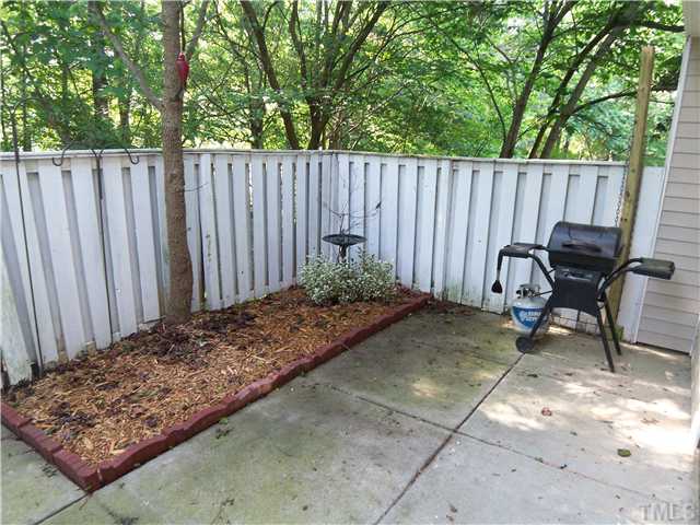 7300 Sandy Creek Drive Raleigh, NC 27615 - Photo 22 of 25 a backyard of a house with table and chairs