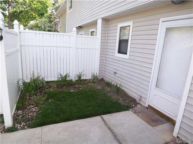 7300 Sandy Creek Drive Raleigh, NC 27615 - Photo 3 of 25 a view of a backyard with a garden