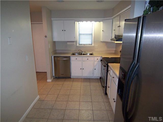 7300 Sandy Creek Drive Raleigh, NC 27615 - Photo 7 of 25 a kitchen with stainless steel appliances granite countertop a refrigerator and a sink