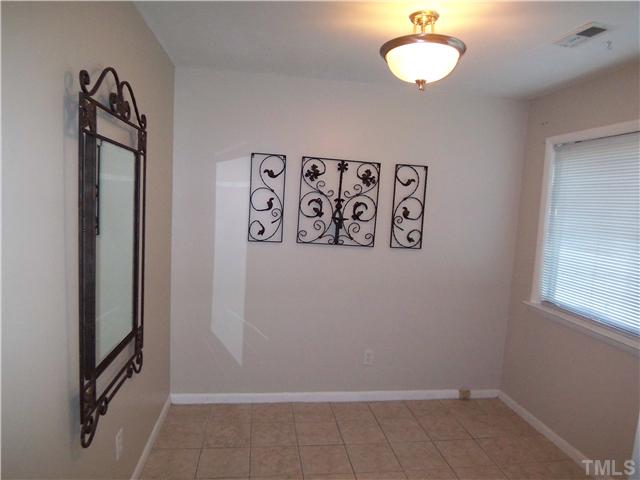 7300 Sandy Creek Drive Raleigh, NC 27615 - Photo 8 of 25 an empty room with a window