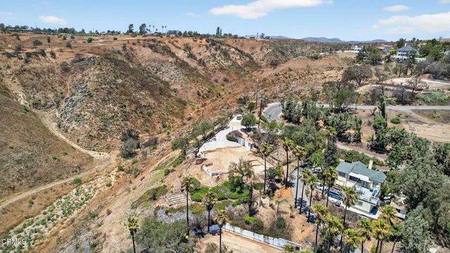 an aerial view of residential house with green space