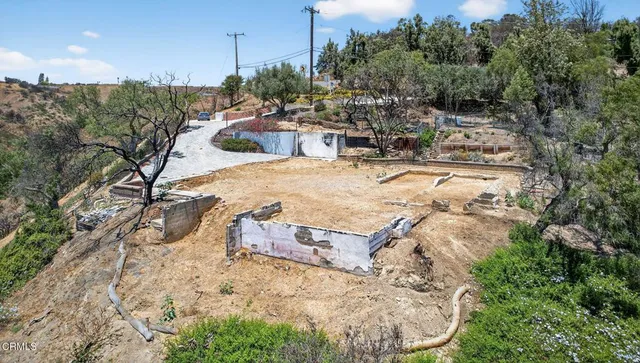 an aerial view of a house with a yard and garden
