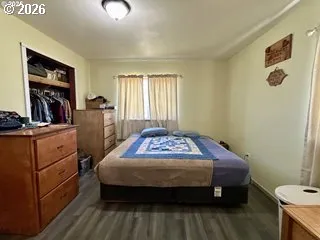 a bedroom with a bed and a dresser