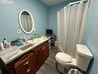 a bathroom with a toilet a sink and a mirror