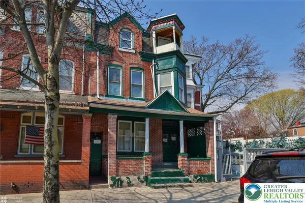 a front view of a houses on the roadside