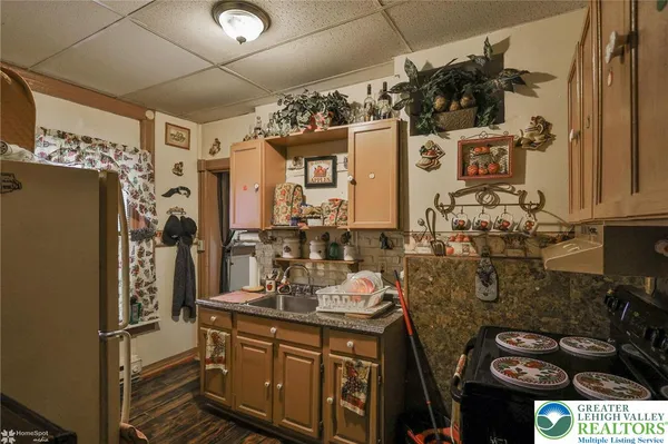 a kitchen with stainless steel appliances granite countertop a stove and cabinets