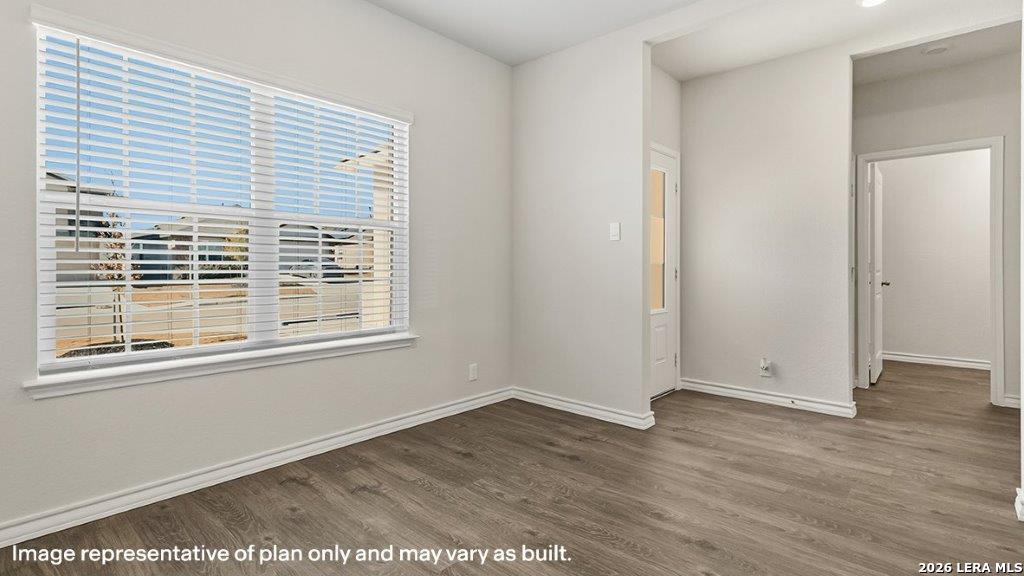 523 Avalon Banks Cibolo, TX 78108 - Photo 17 of 79 a view of an empty room with wooden floor and a window