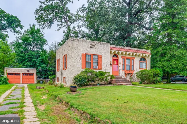 a front view of house with yard and green space