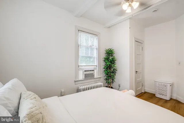 a bedroom with a bed and a potted plant