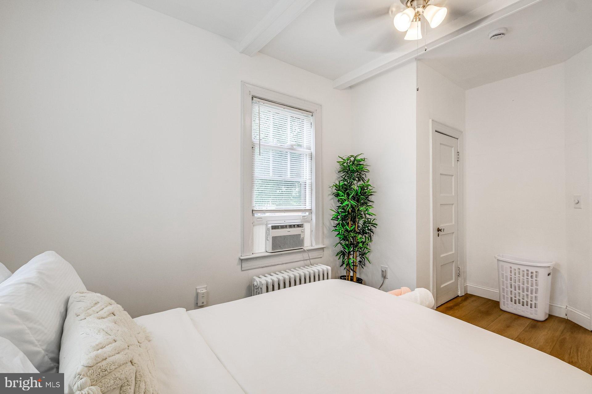 4209 Queensbury Road Hyattsville, MD 20781 - Photo 11 of 12 a bedroom with a bed and a potted plant
