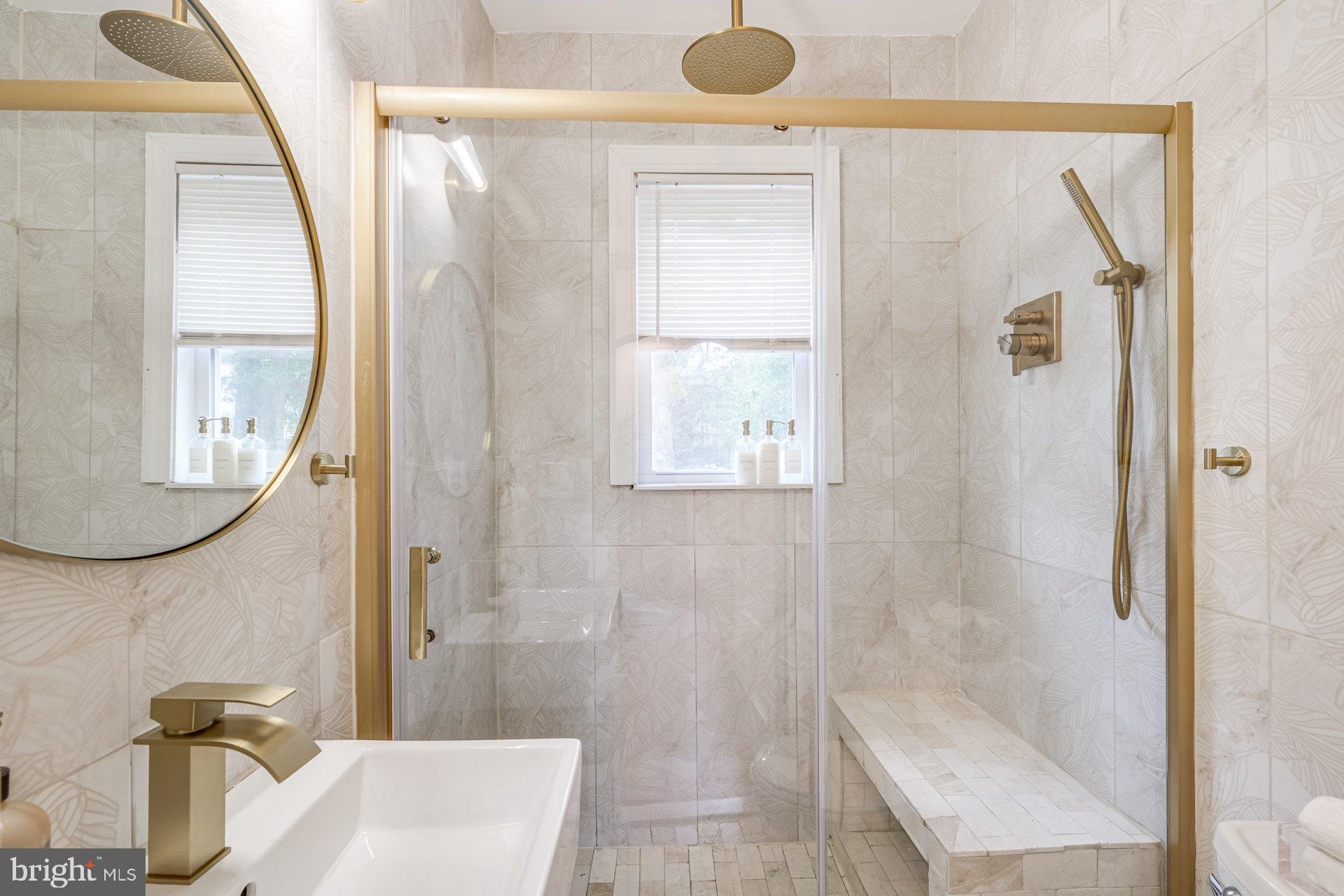 4209 Queensbury Road Hyattsville, MD 20781 - Photo 12 of 12 a bathroom with a sink a mirror and a shower