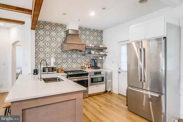 a kitchen with a stove and a refrigerator