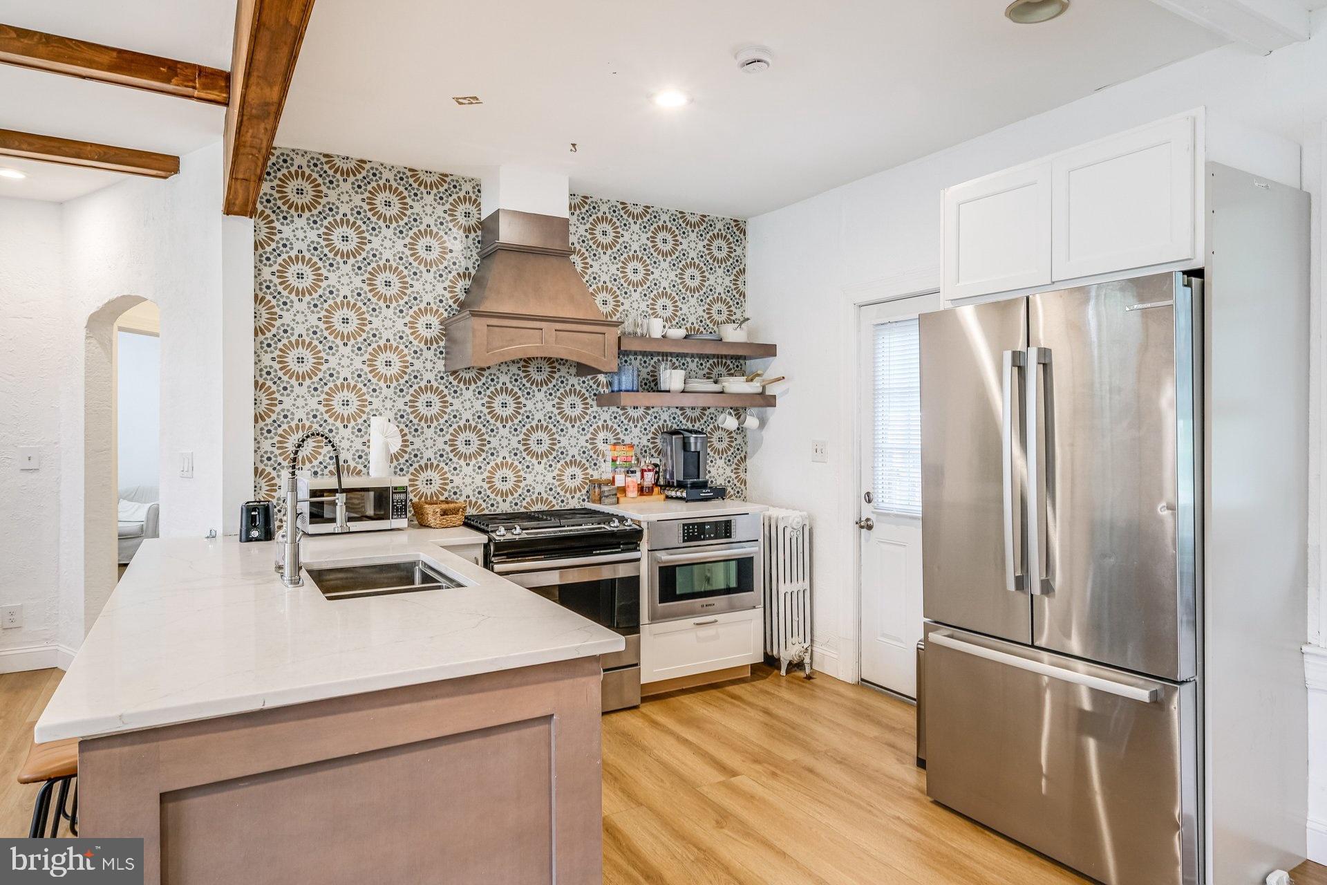 4209 Queensbury Road Hyattsville, MD 20781 - Photo 5 of 12 a kitchen with a stove and a refrigerator