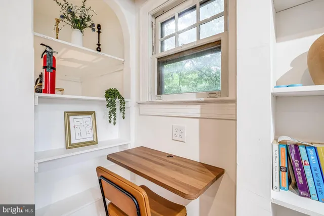 a hallway with a bed and a book shelf