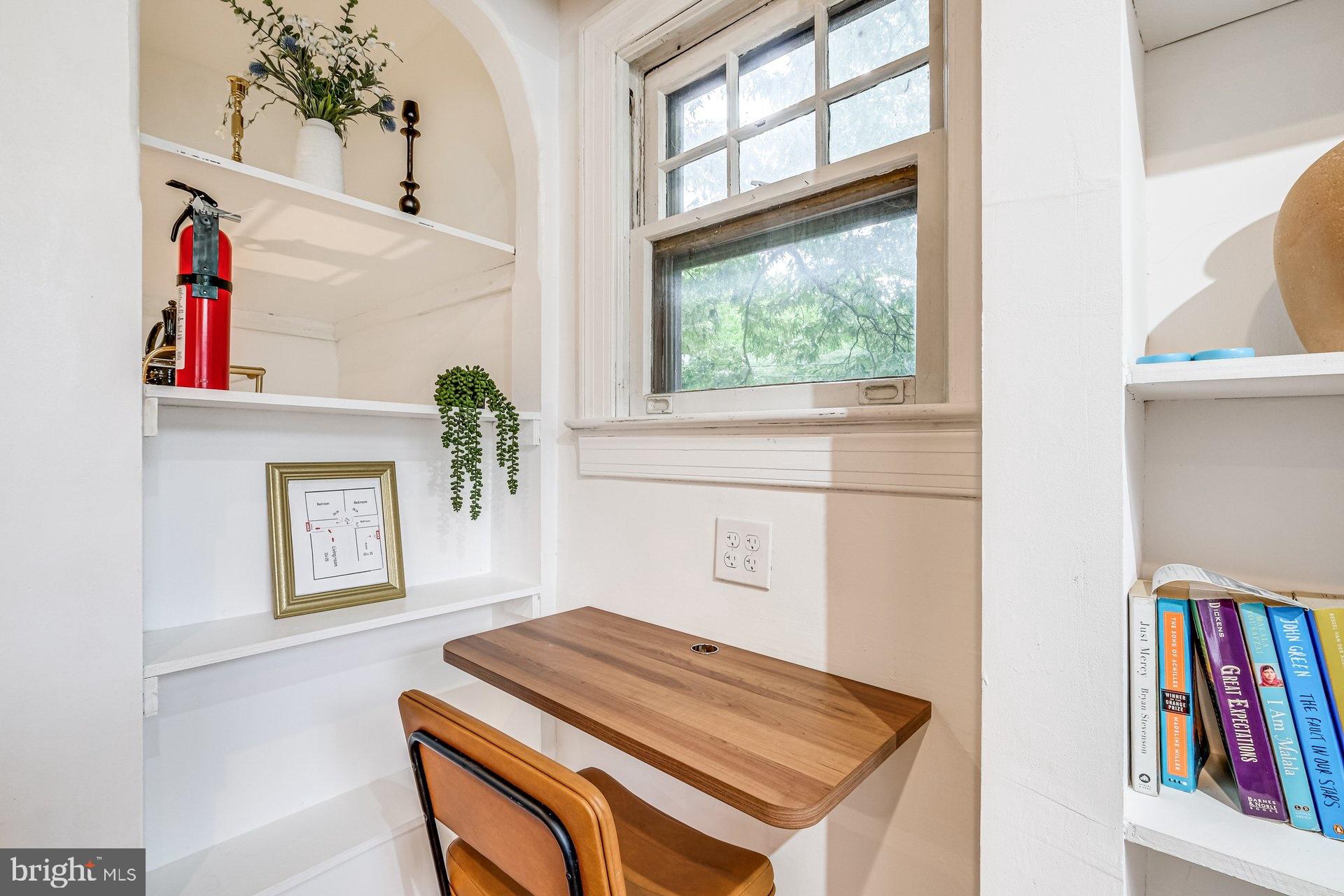 4209 Queensbury Road Hyattsville, MD 20781 - Photo 9 of 12 a hallway with a bed and a book shelf