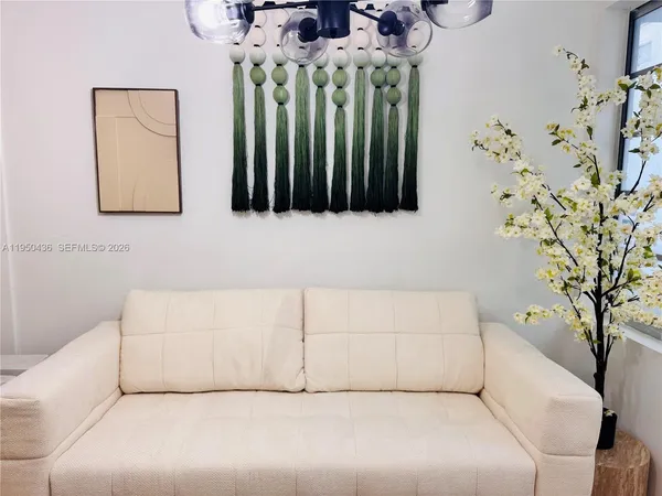a living room with a couch and a chandelier