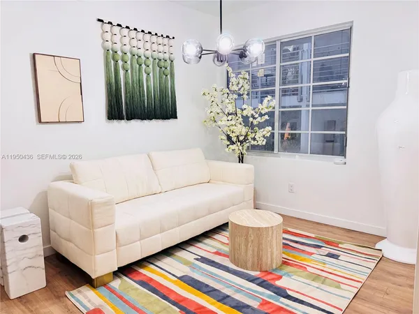 a living room with a couch and a potted plant