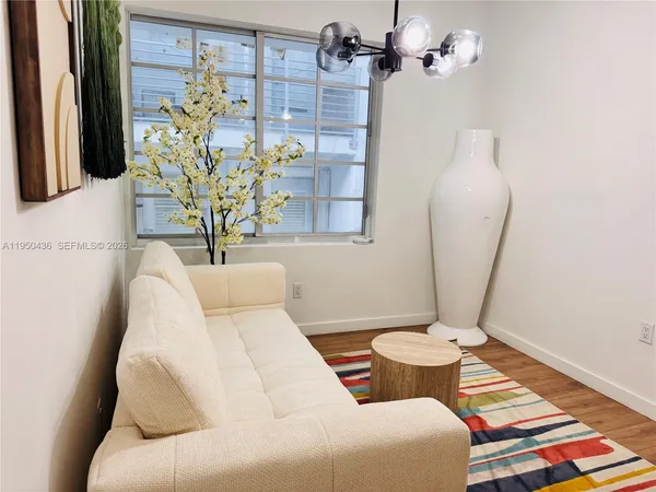a living room with a couch and a chandelier