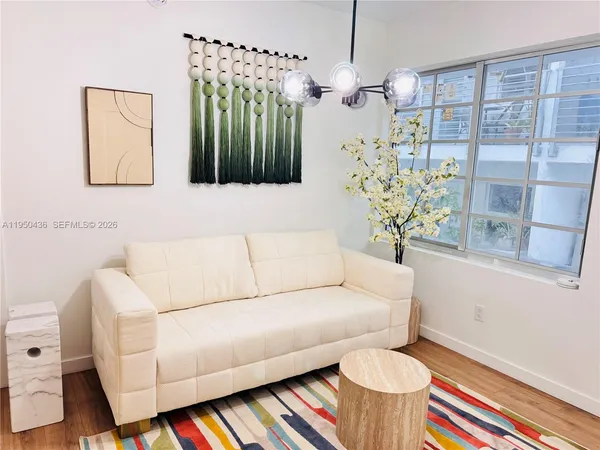 a living room with furniture and a chandelier