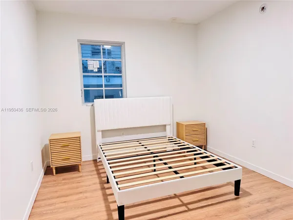 a view of wooden floor and windows in a room