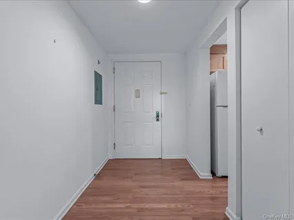 a view of a hallway with wooden floor