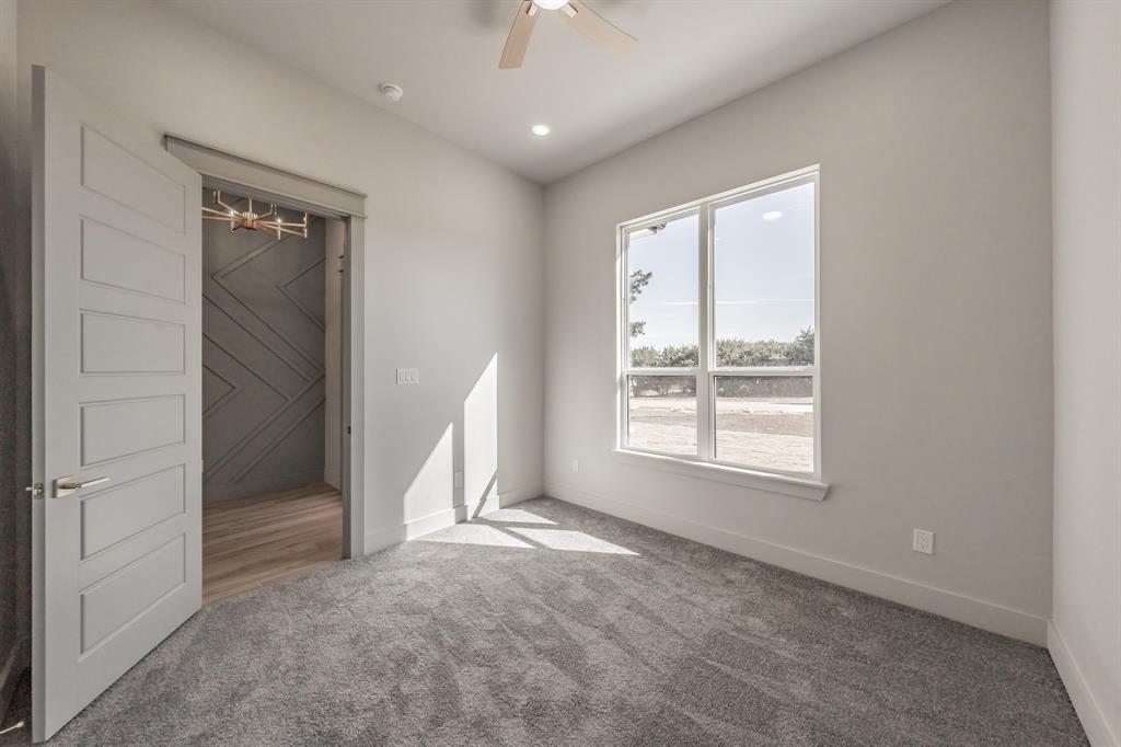 7805 Kenleigh Lane Rio Vista, TX 76093 - Photo 21 of 40 Unfurnished bedroom with carpet floors and a ceiling fan