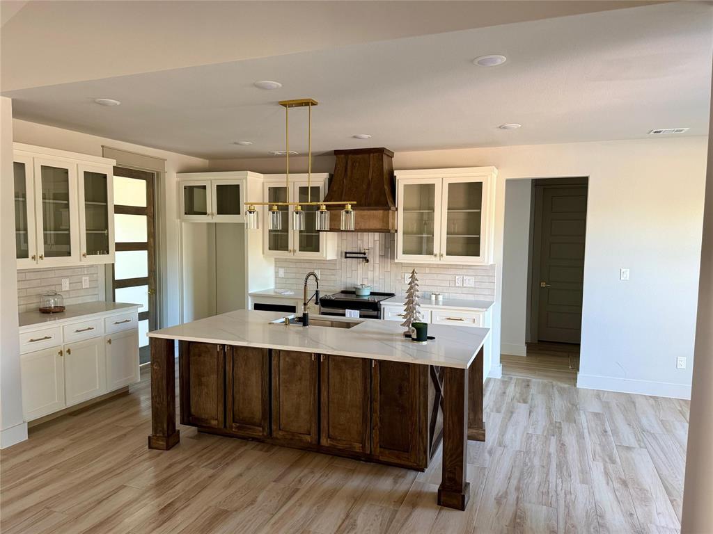 7805 Kenleigh Lane Rio Vista, TX 76093 - Photo 28 of 37 a kitchen with a stove a sink and wooden floor