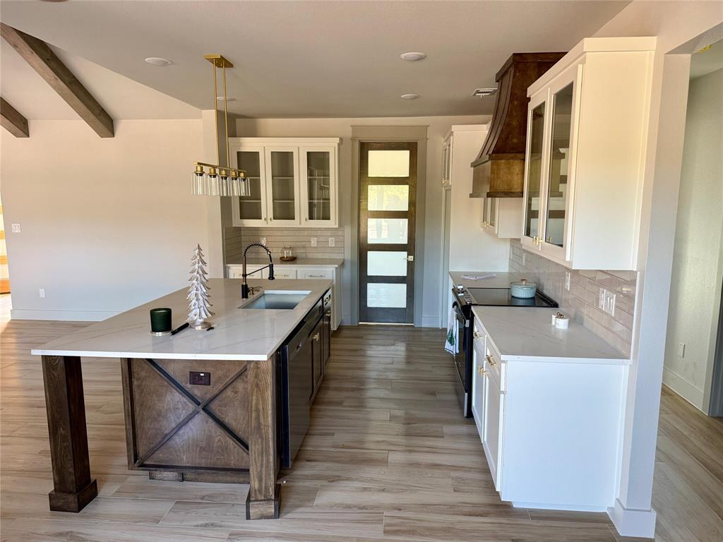 7805 Kenleigh Lane Rio Vista, TX 76093 - Photo 32 of 37 a kitchen with a sink a window and chairs