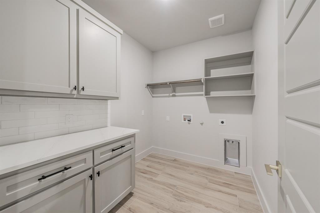 7805 Kenleigh Lane Rio Vista, TX 76093 - Photo 31 of 40 Laundry room with gas dryer hookup, light wood-style flooring, hookup for a washing machine, cabinet space, and hookup for an electric dryer