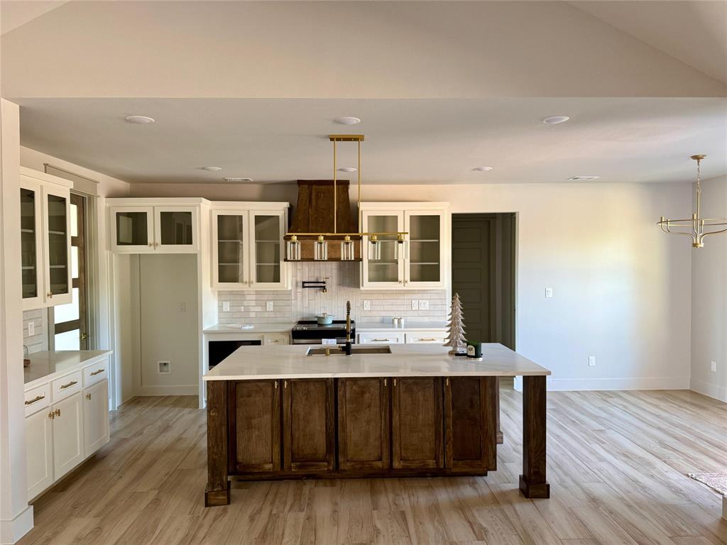 7805 Kenleigh Lane Rio Vista, TX 76093 - Photo 35 of 37 a kitchen with a sink cabinets and wooden floor