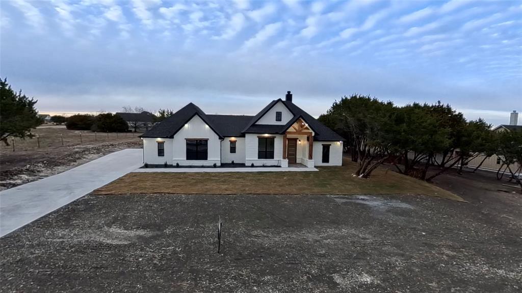 7805 Kenleigh Lane Rio Vista, TX 76093 - Photo 5 of 40 Modern inspired farmhouse featuring a chimney and driveway