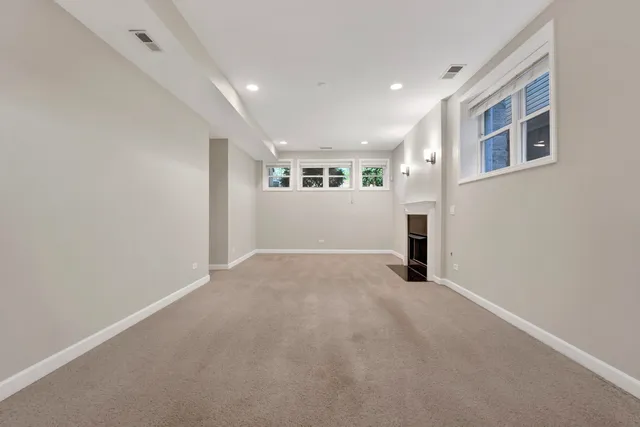 a view of empty room with a fireplace