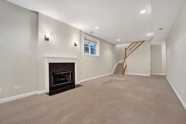 a view of empty room with a fireplace