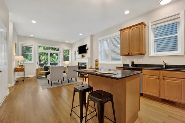 a kitchen with stainless steel appliances granite countertop sink stove and wooden cabinets