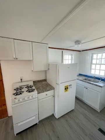 a white refrigerator freezer sitting inside of a kitchen