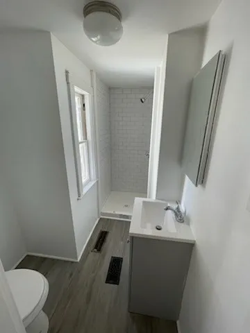 a bathroom with a sink mirror vanity and toilet