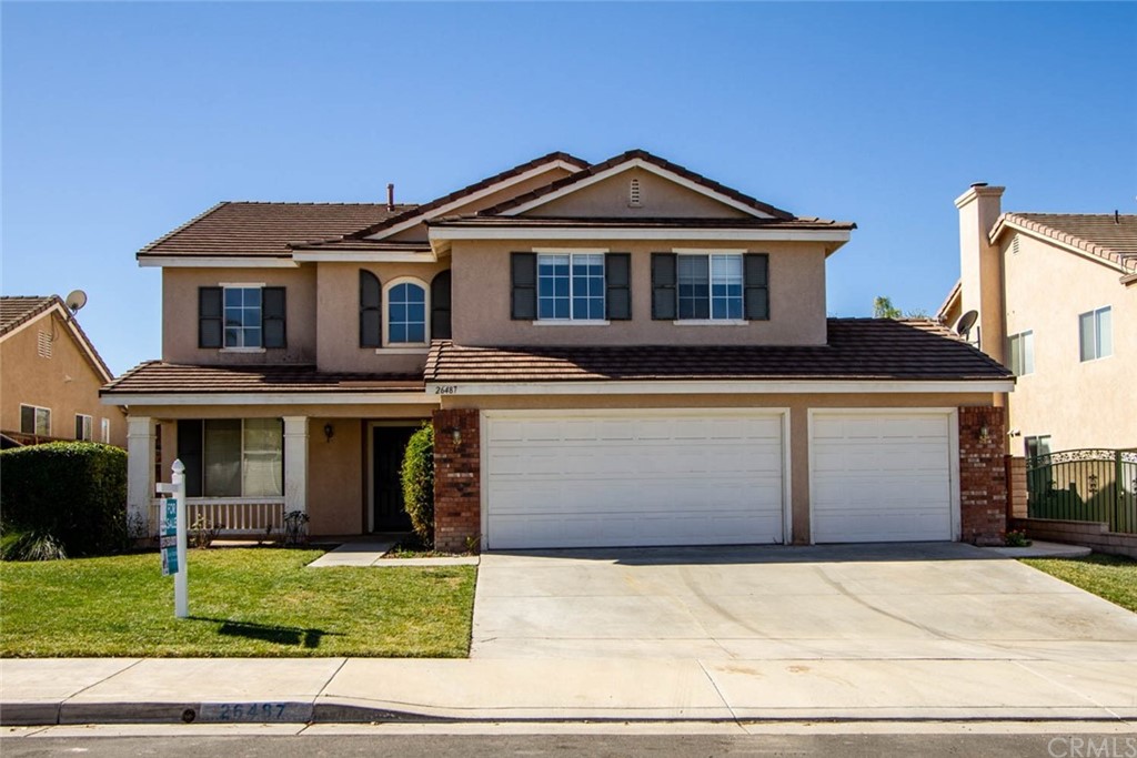 26487 Roland Road Murrieta, CA 92563 - Photo 1 of 1 a front view of a house with a garden