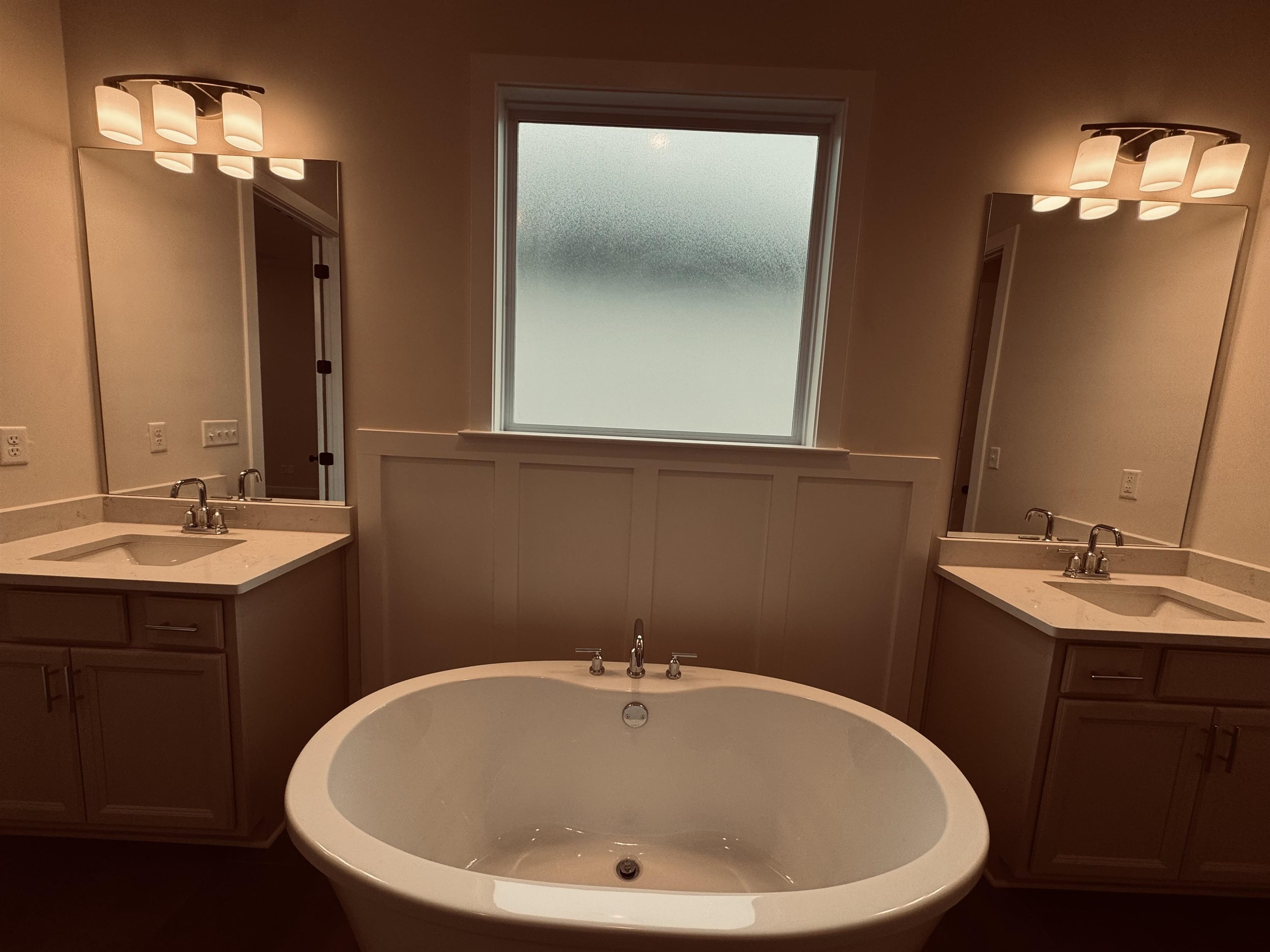 Bathroom featuring a washtub and vanity