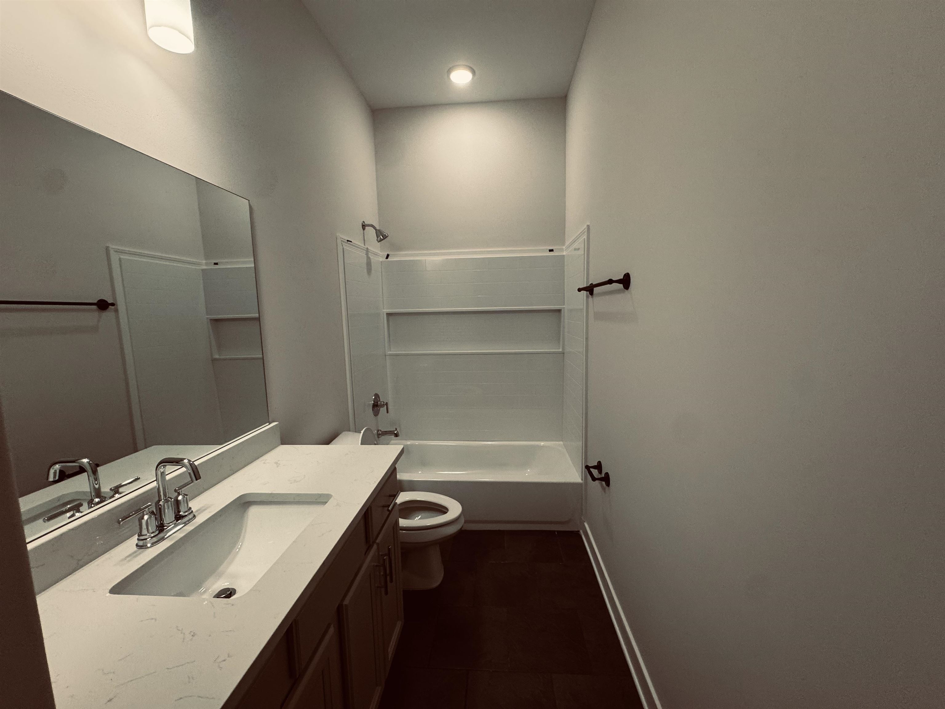 5714 Gerber Road Arlington, TN 38002 - Photo 9 of 19 Full bathroom with tile patterned floors, vanity, toilet, and washtub / shower combination
