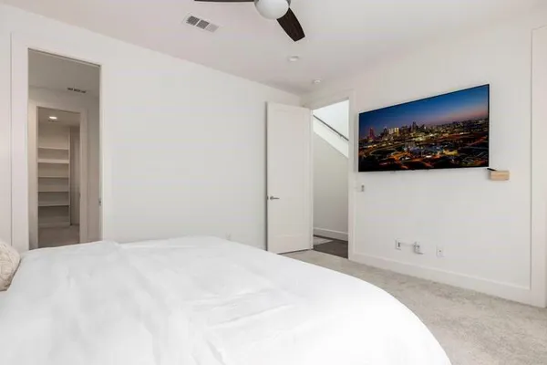 a bedroom with a bed and a painting on the wall