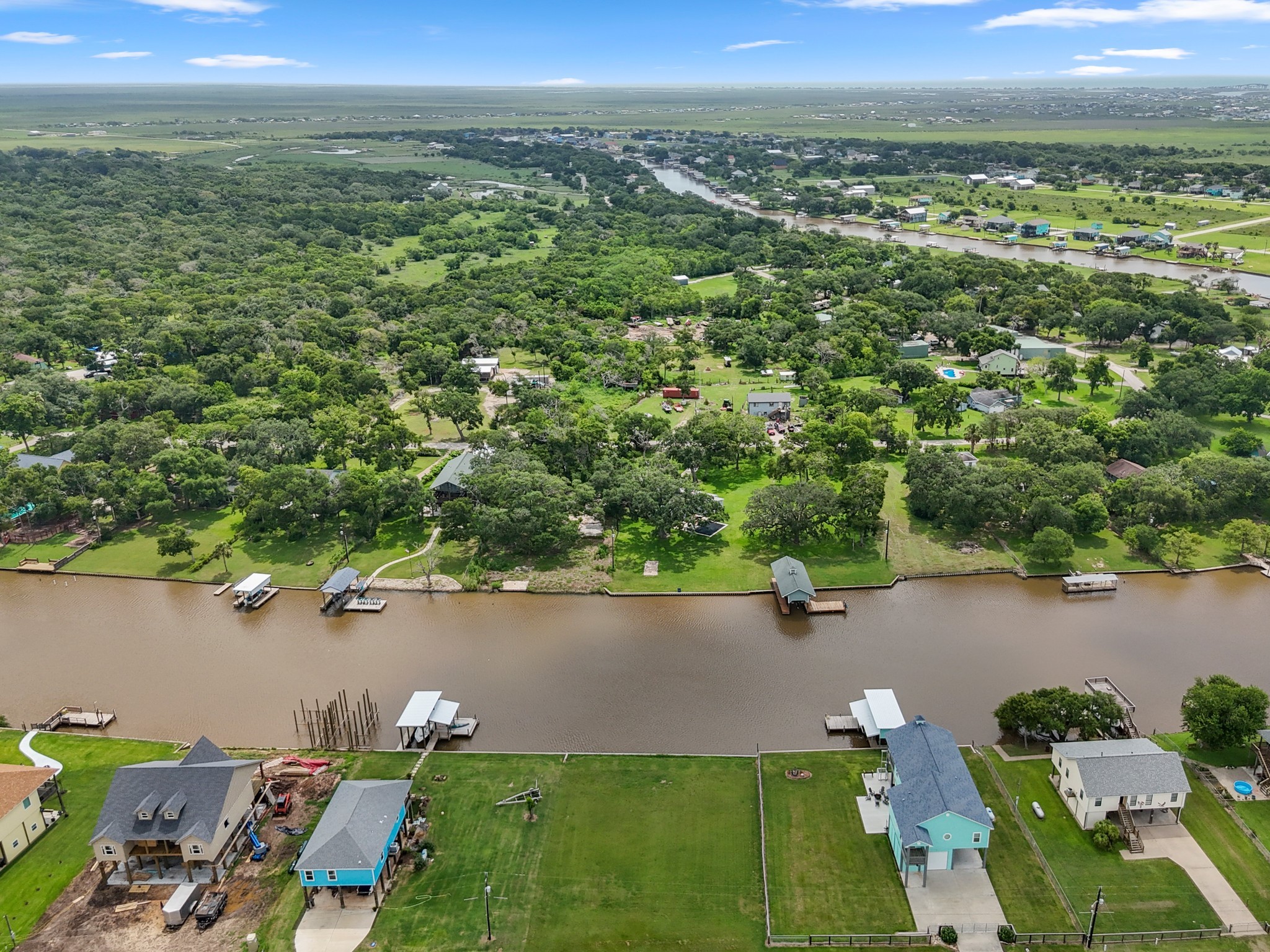 7 County Road 291 Sargent, TX 77414 - Photo 3 of 19 an aerial view of a house with a yard and lake view