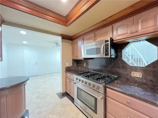 a kitchen with stainless steel appliances granite countertop a stove and a sink