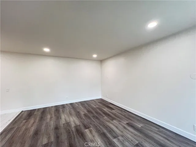 a view of room with wooden floor and fan