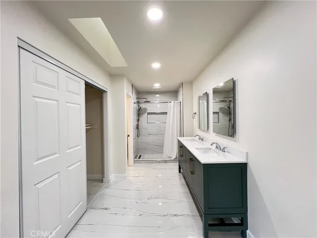 a bathroom with a sink a mirror and a shower