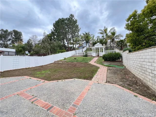 front view of a house with a yard and potted plants