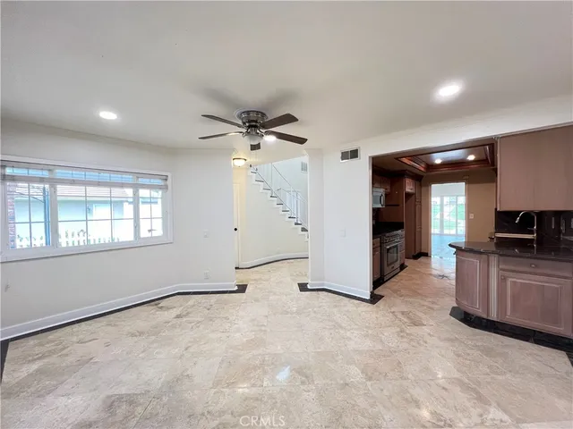 a view of a kitchen with a sink and a refrigerator