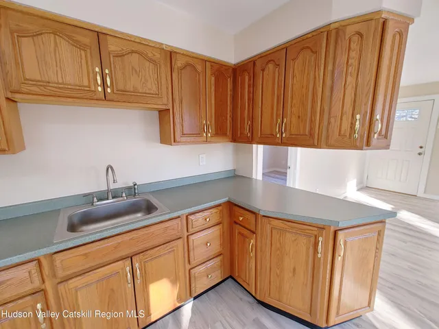 a kitchen with stainless steel appliances granite countertop wooden cabinets a sink and dishwasher