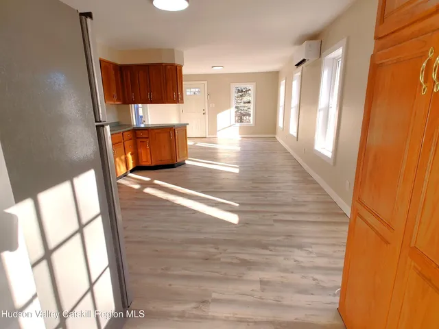 a view of a room with wooden floor and windows